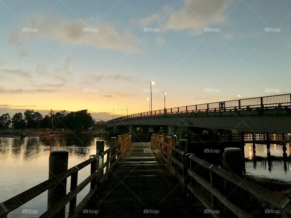Early morning lights up the bridge and boardwalk. Carrington, NSW Australia 
