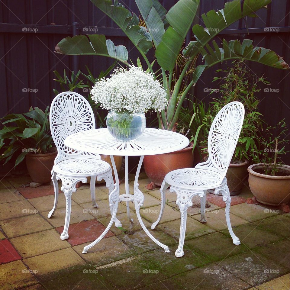 Table Decorations. Large bowl of white Gypsophlia on a garden table.