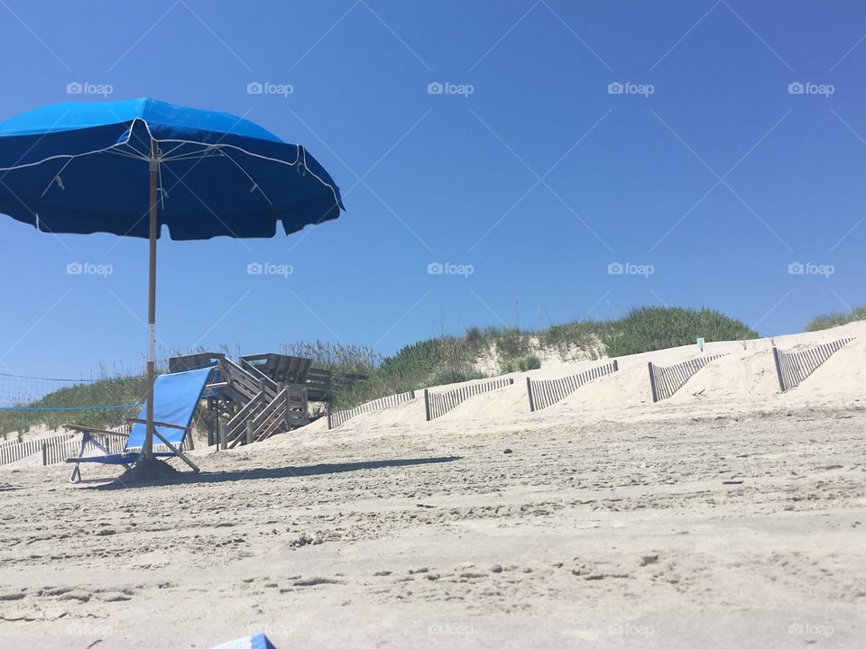 A chair and umbrella on the beach