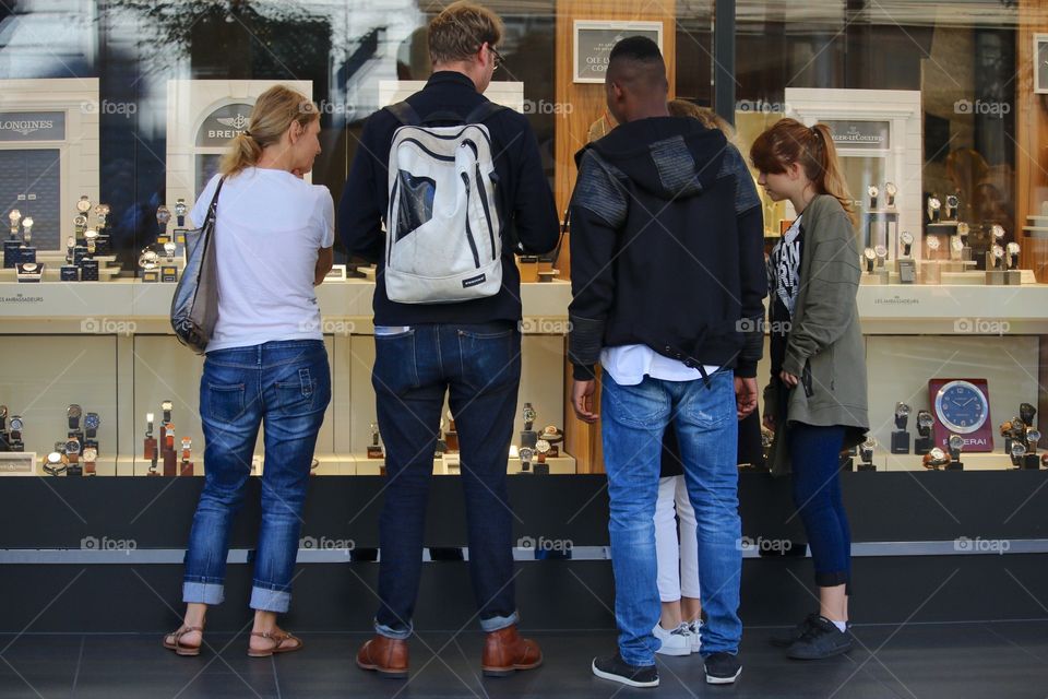 People Looking At Watches Through Shop Glass Window In Zürich