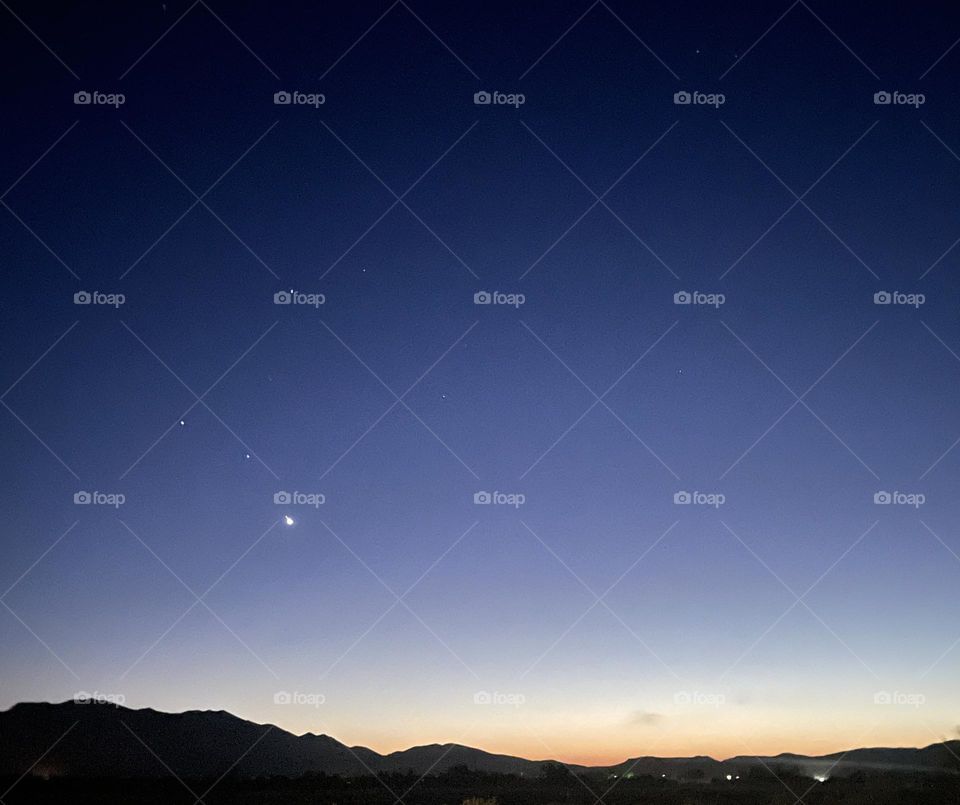 Stars and sunset with mountains.