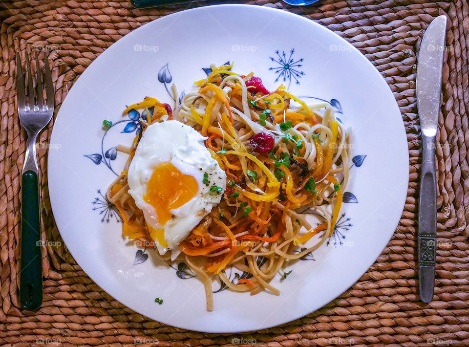 Egg and spaghetti on plate