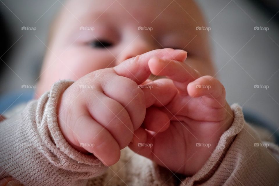 Baby playing with hands