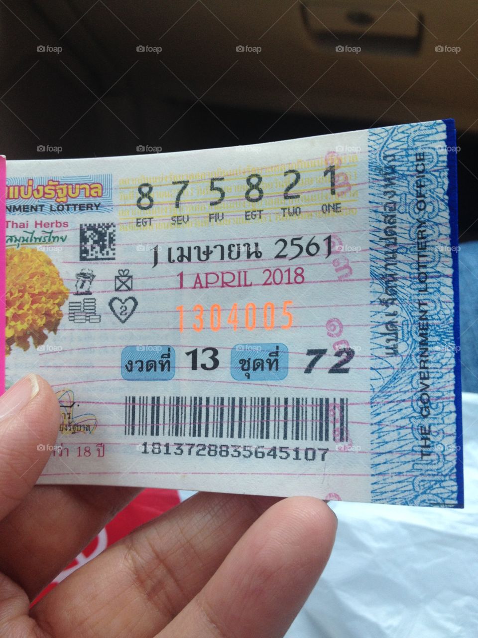 Thailand lottery in hand.