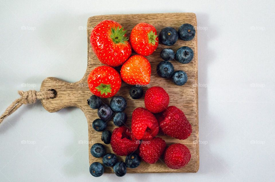 Eating more fruit! Forest fruit on a wooden shelf