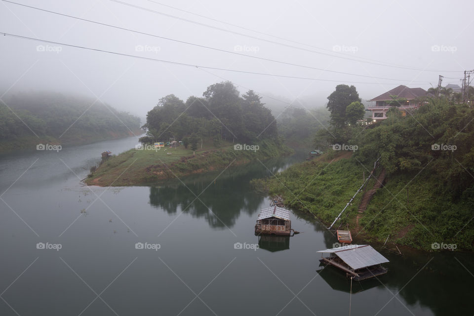 Houses in the river with mist fog