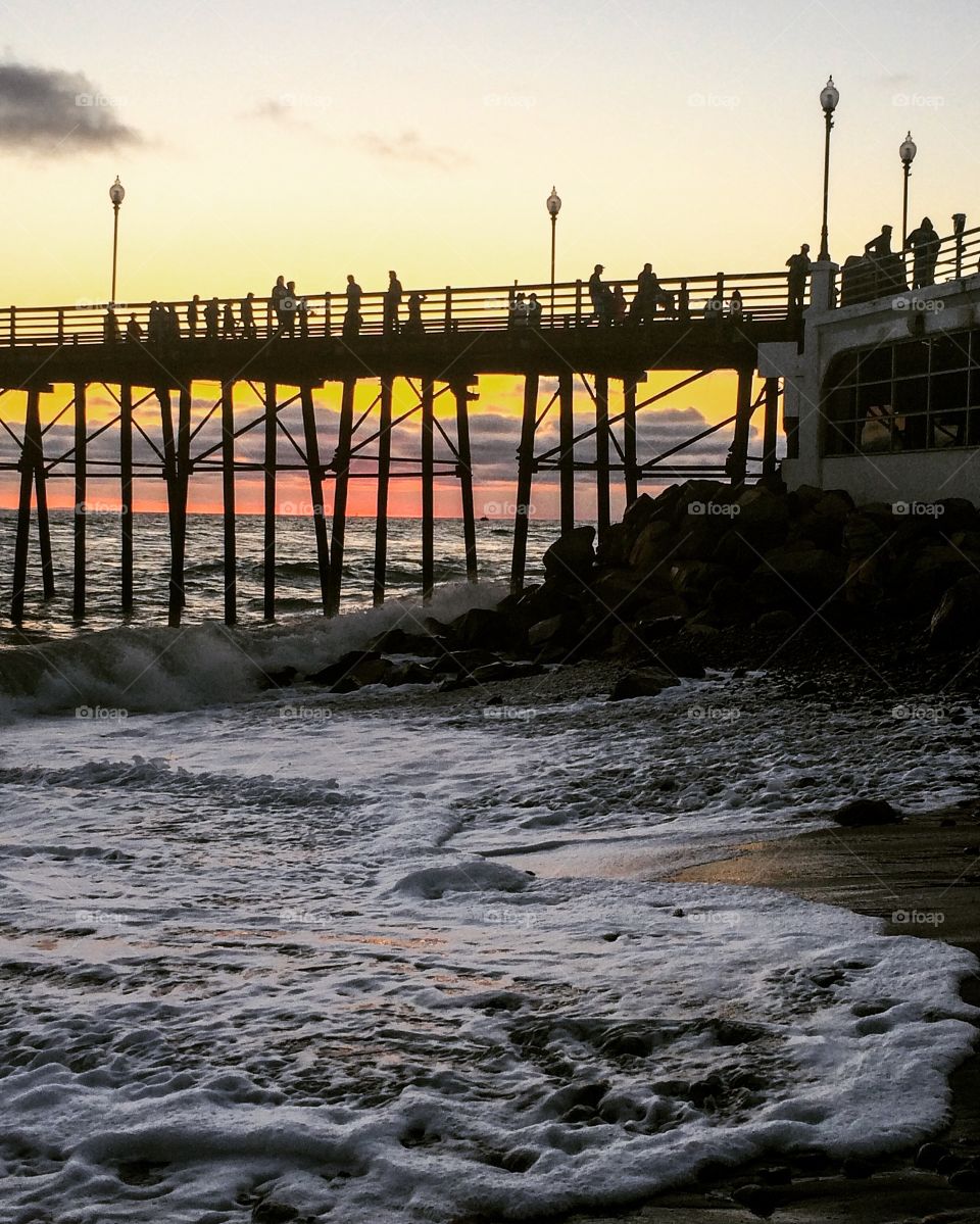 Tourist on pier during sunset