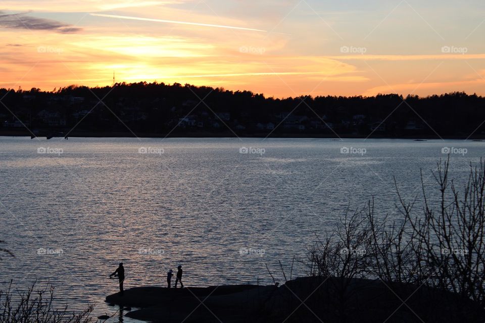 People fishing at sunset