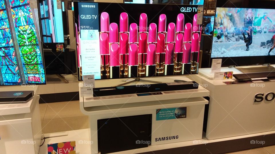 Samsung QLED television 4K Ultra High Definition TV with soundbar and sub-woofer on plinths at Peter Jones department store