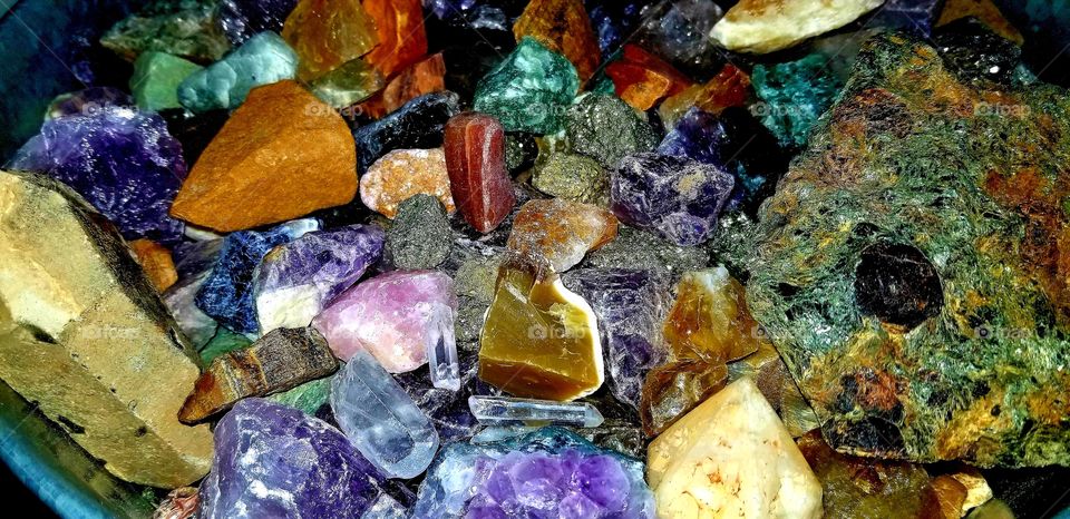 bucket full of colorful gemstones