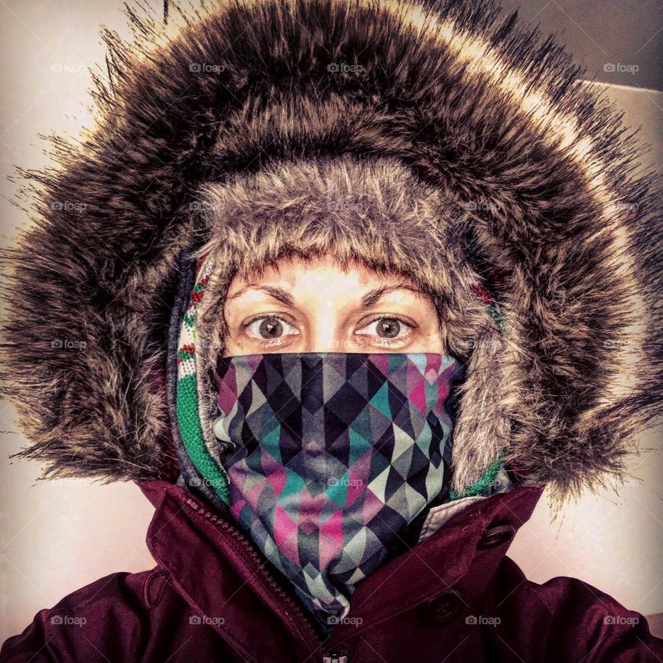 Woman ready to go for a walk, woman all bundled up, ready for cold weather, walking to the store in cold climate 