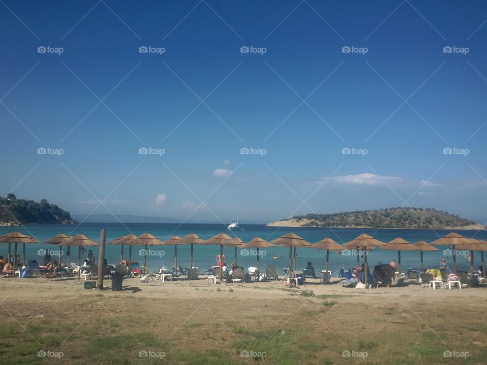 Sand beach with sunbeds. Greece