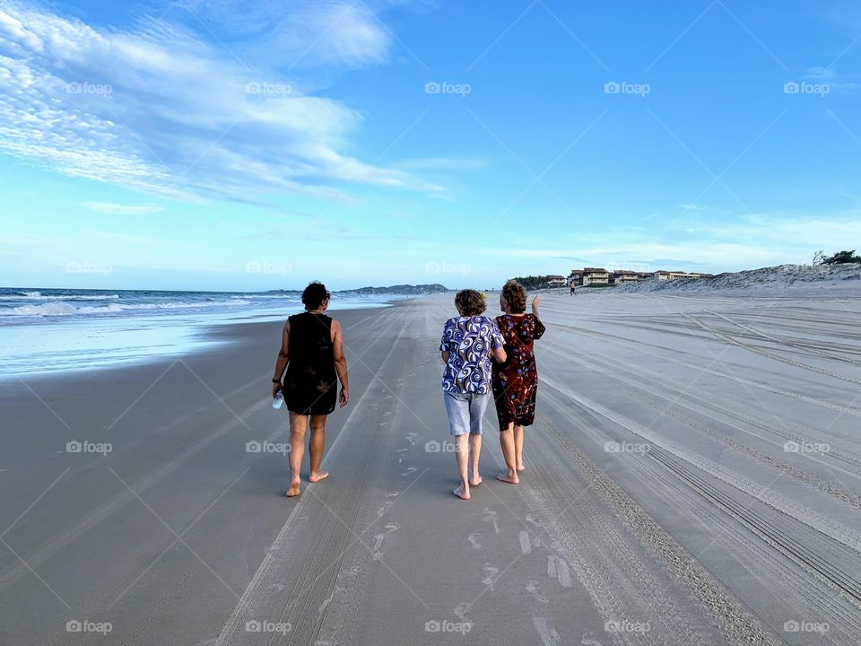 Three women walking on the beach