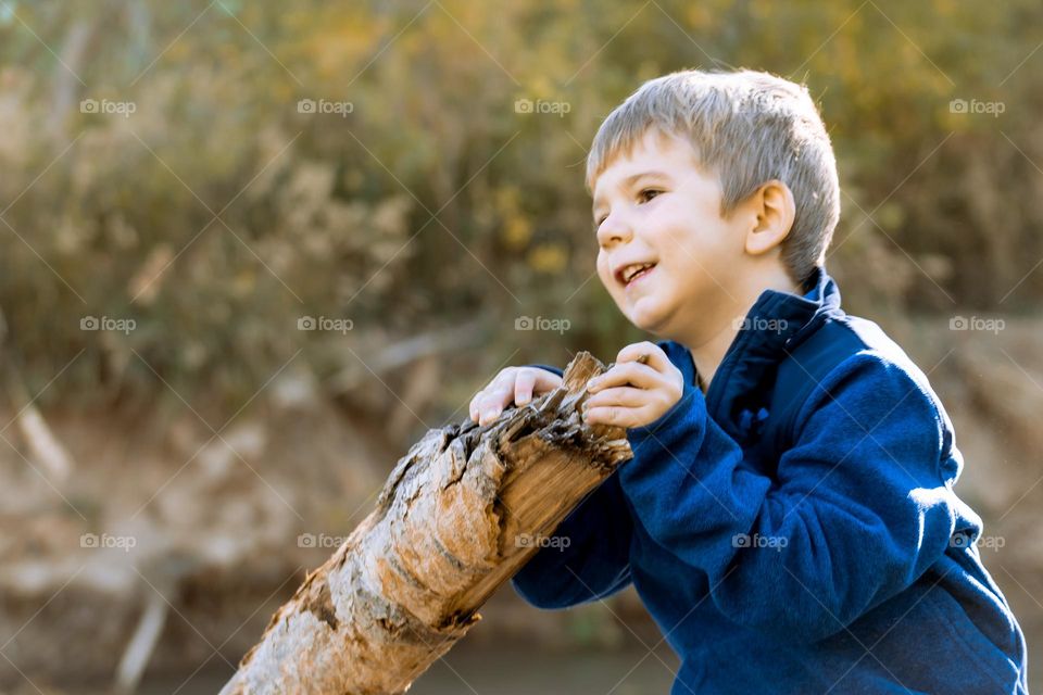 Child with branch in fall