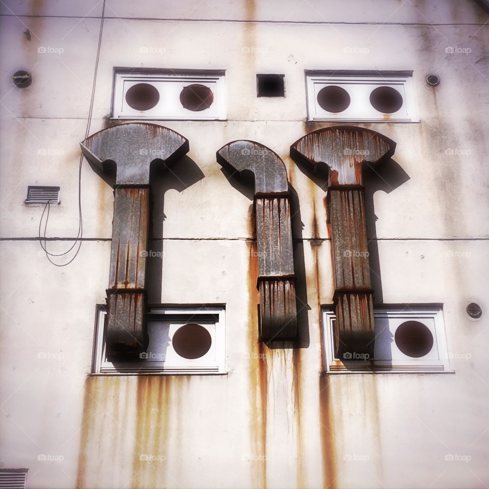 Rusty ventilators on a wall