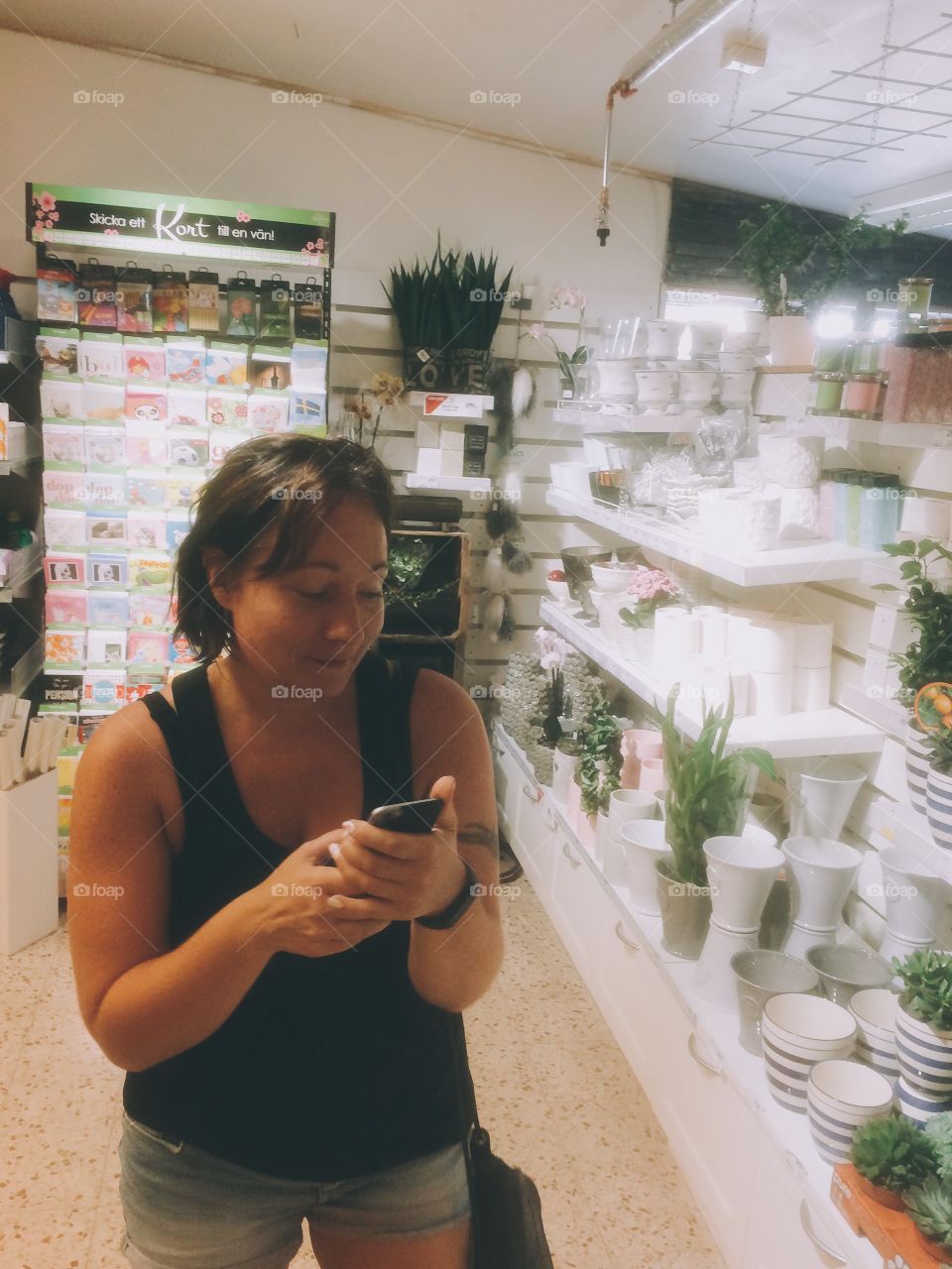 Woman using her phone in a shop