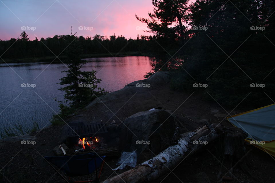 Campsite fire at sunset in the Boundary Waters