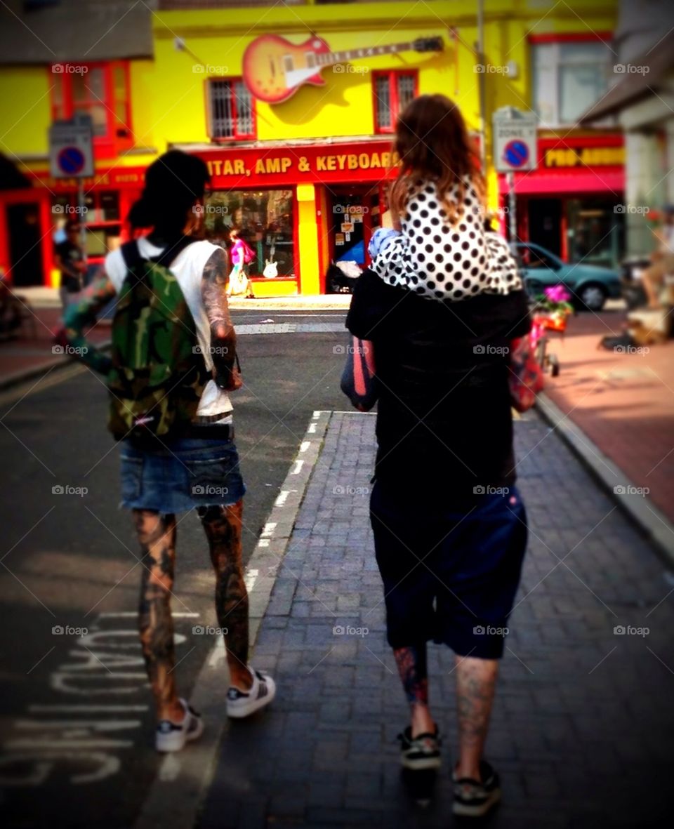Heavily tattooed couple and child at Brighton