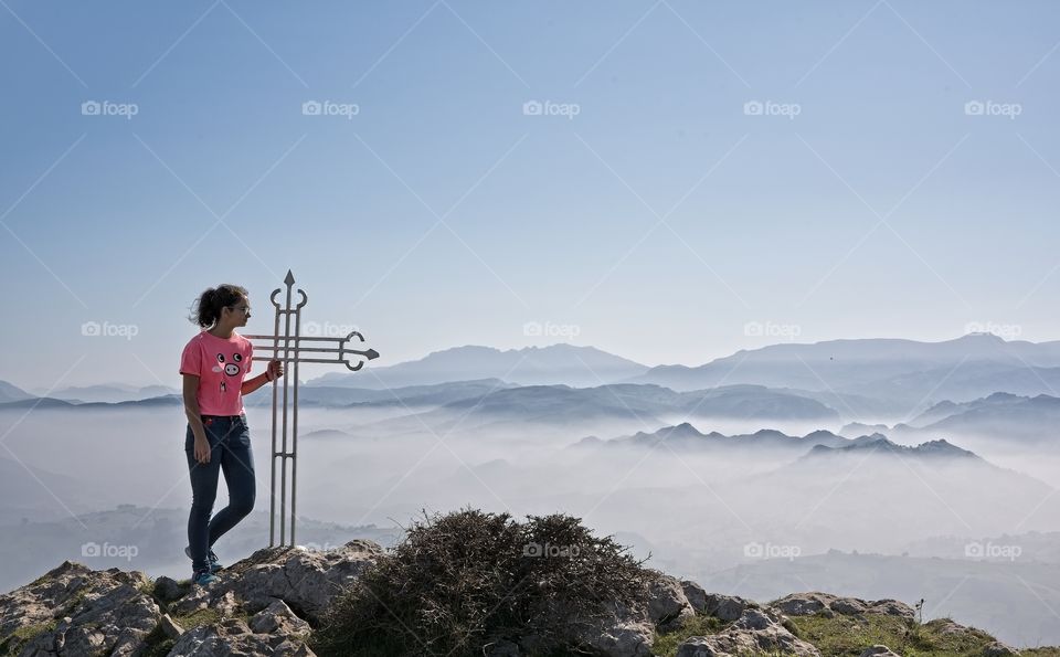 Girl on top of a mountain 