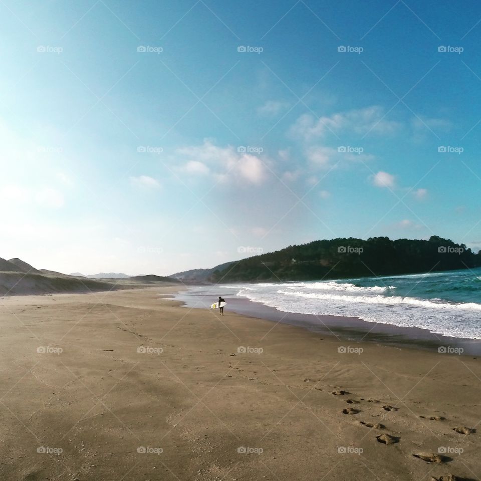 Lonely surfer. my friend came out of the water where he surfed big waves