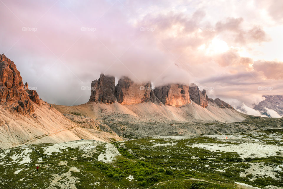 Tre Cime Dolomites Italy in the clouds during sunset