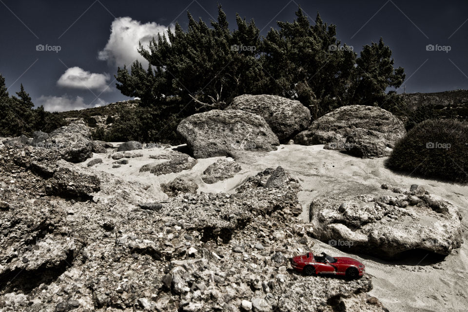 abandoned car on the rock