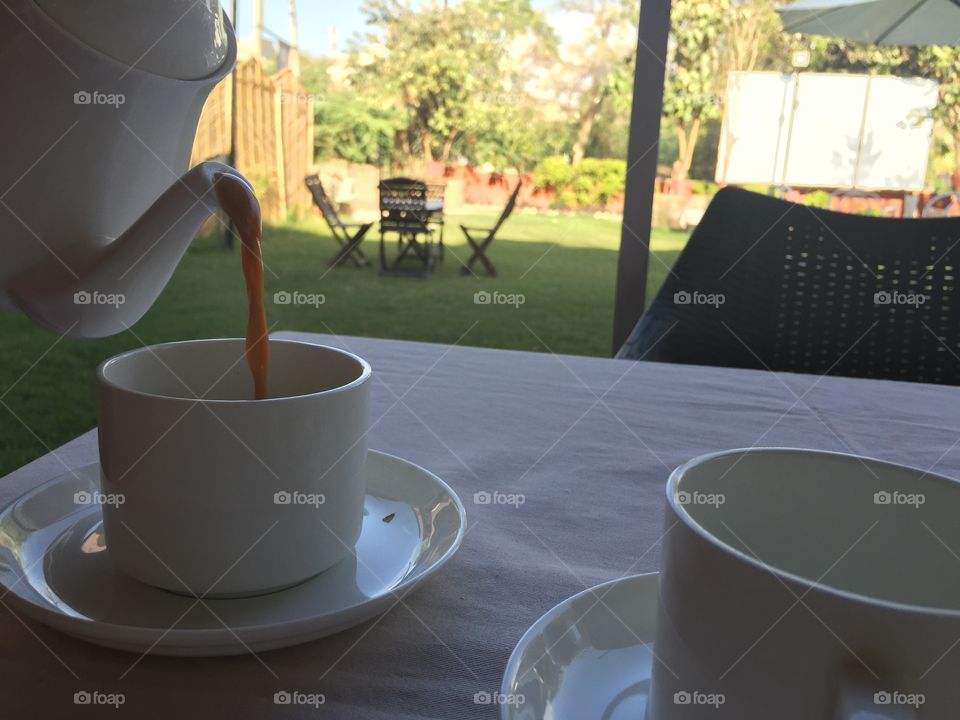 Enjoying a pot of chai tea in a garden in India.