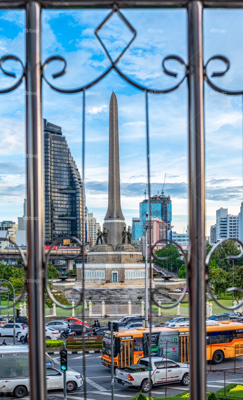 Beautiful sunset scene behind the land mark Victory Monument in Bangkok Thailand