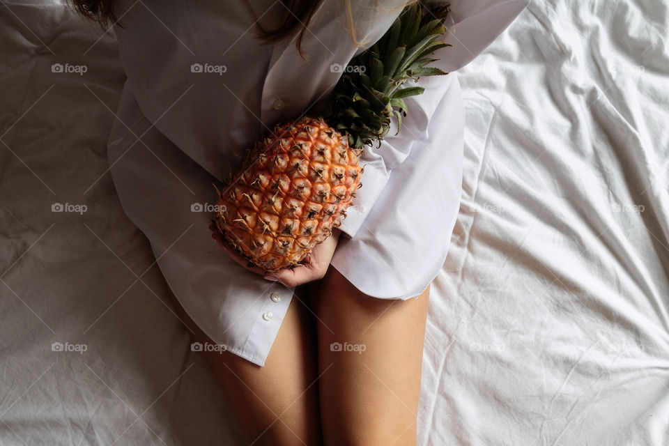 Woman holding fresh pineapple 