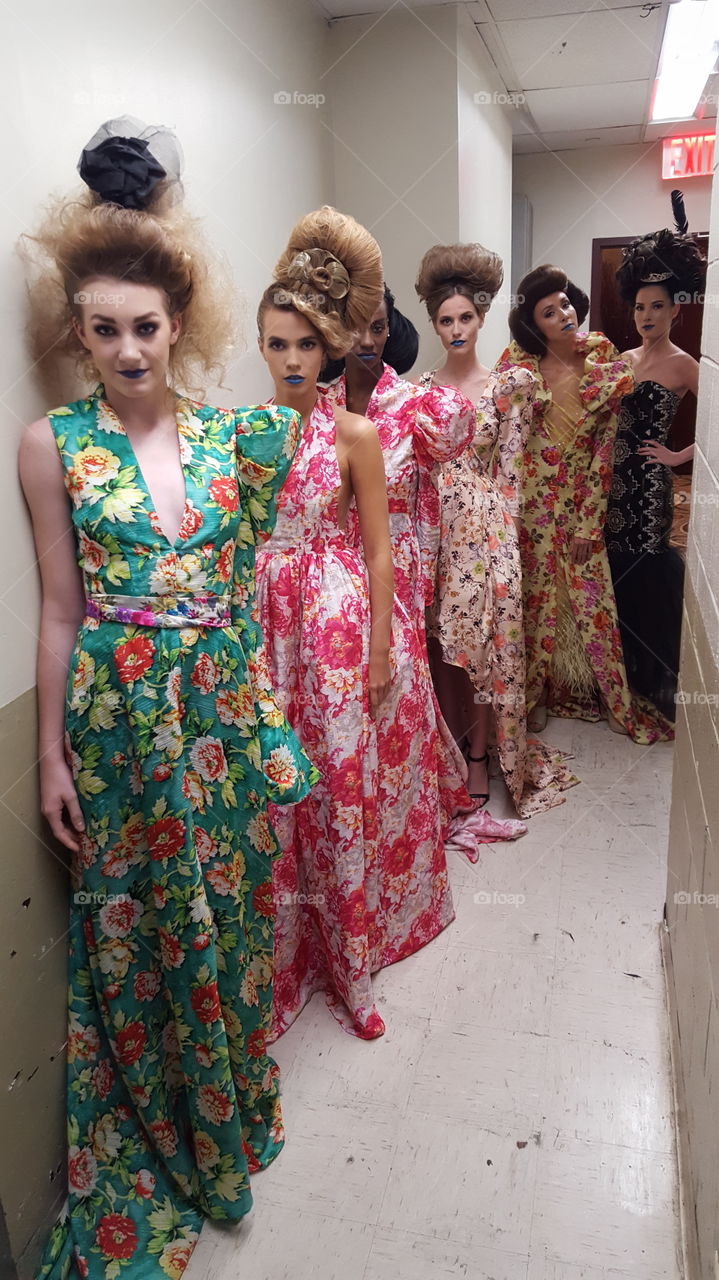 Models wait for their moment to walk, backstage at Couture Fashion Week New York.