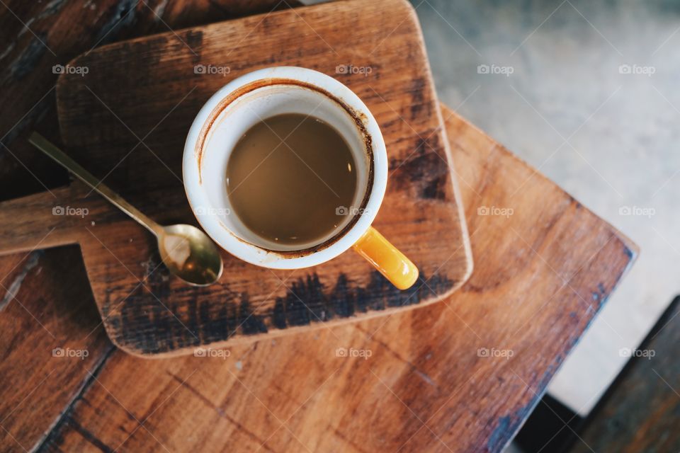 High angle view of coffee cup on cutting board