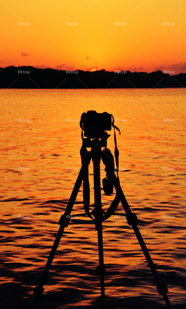 Camera and tripod being photographed during a superior sunset!