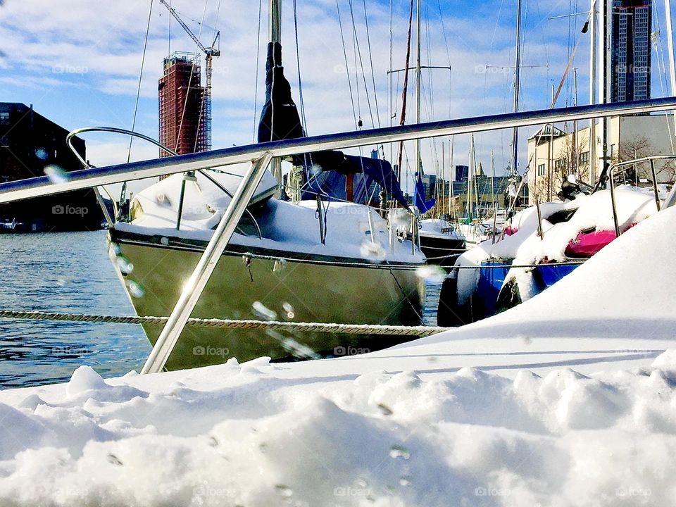 Boats at Newtown Creek in Long Island City, Queens in the winter time covered in ample amounts of sparkling white snow. One has to maneuver around extra carefully in these conditions to get to and fro the boat and the land. 2020. Hypnotic Productions