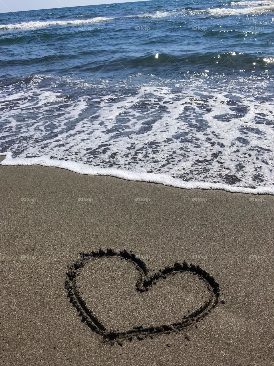 Love is all around us, you can feel it in the air. The heart is drawn on the sand at the beach in Ulcinj, the state of Montenegro.