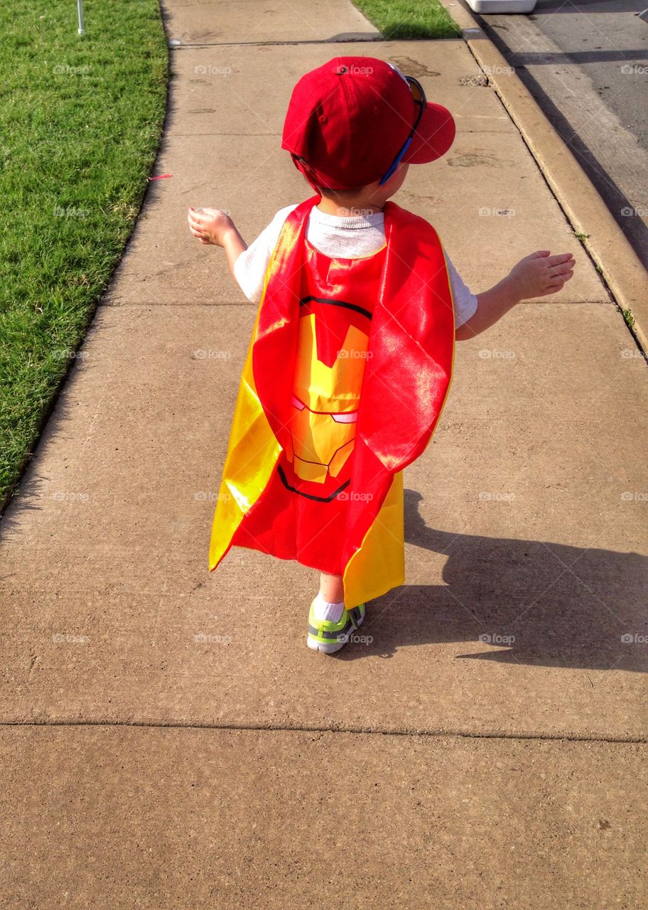 I am iron man. Boy wearing iron man cape