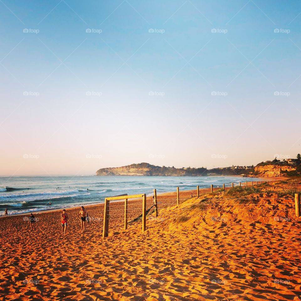 Looking along Mona Vale Beach on a sunny day