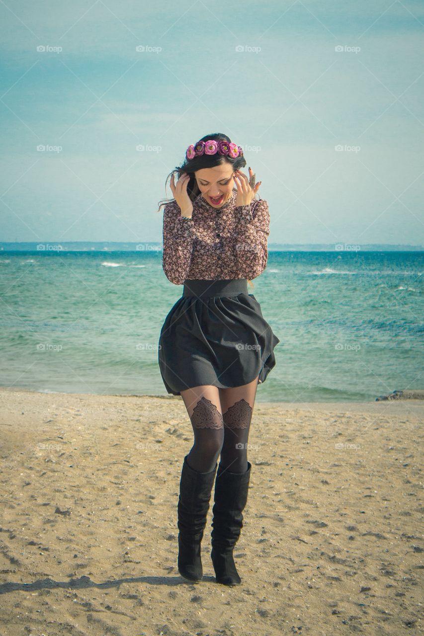 Beautiful woman standing on sand at beach