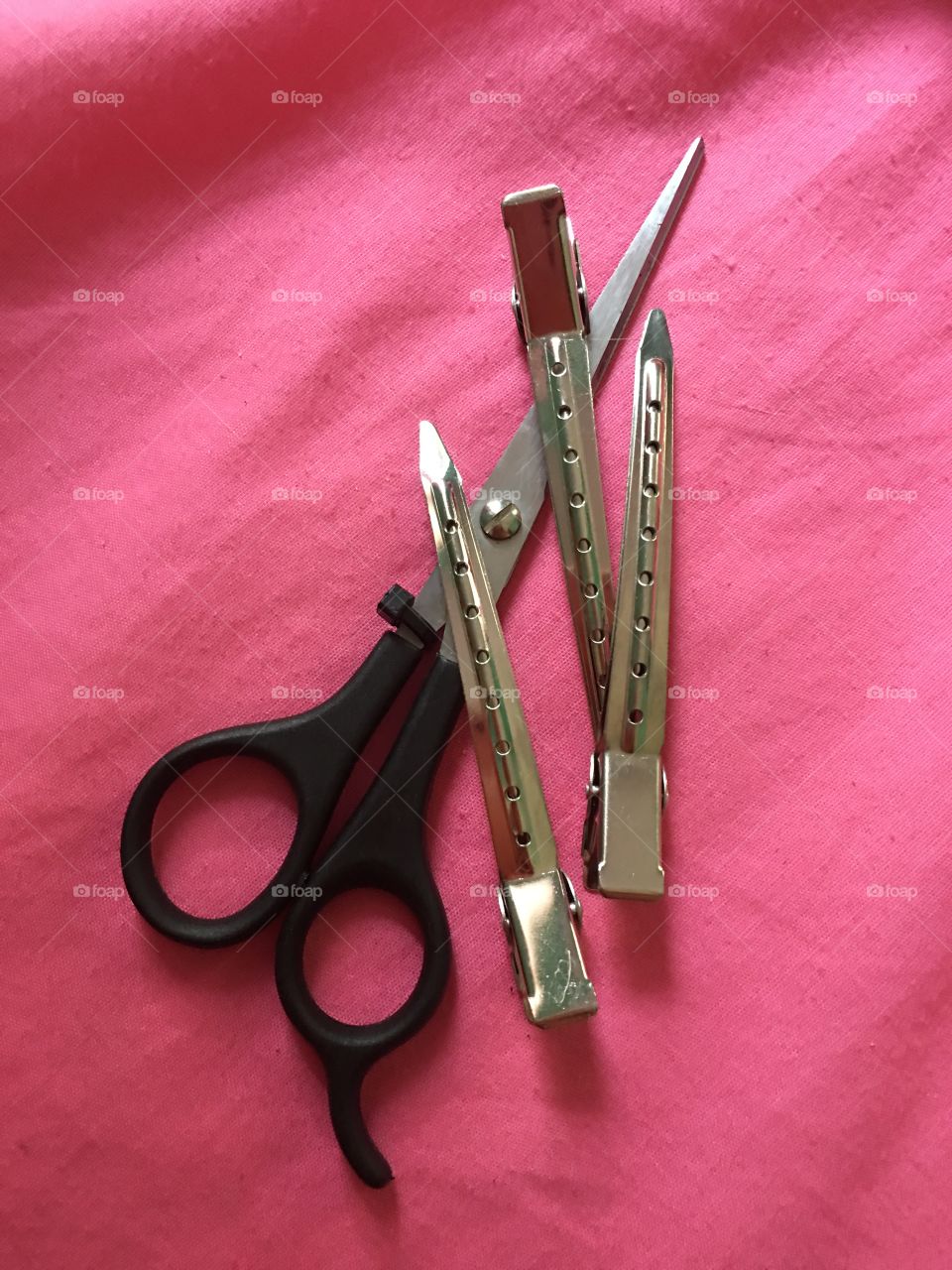 High angle view of scissors with hair clips
