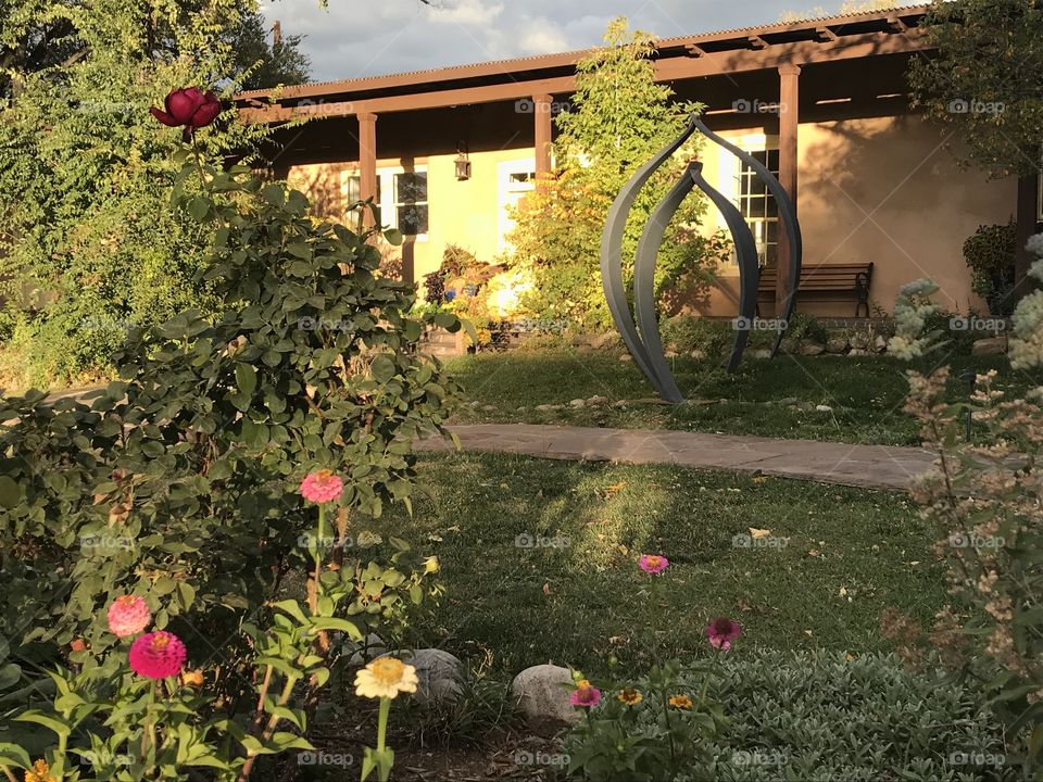 Art gallery in Santa Fe, New Mexico, in the evening light, with a garden in the foreground
