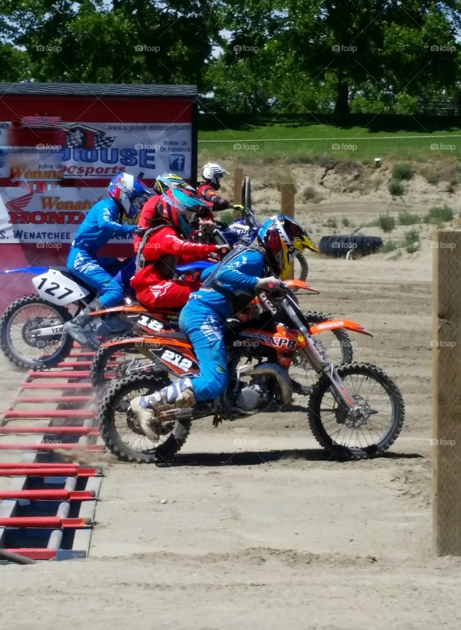 Motorcycle Dirt Bikes at Starting Gate on Sunny Race Day