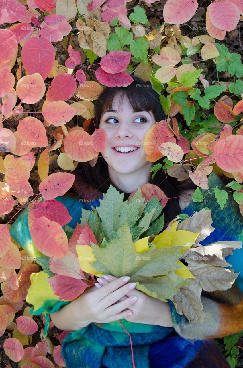 Smiling Young Girl on Autumn Background