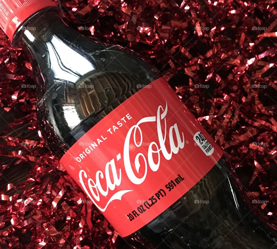 Coca Cola beverage on red tinsel 