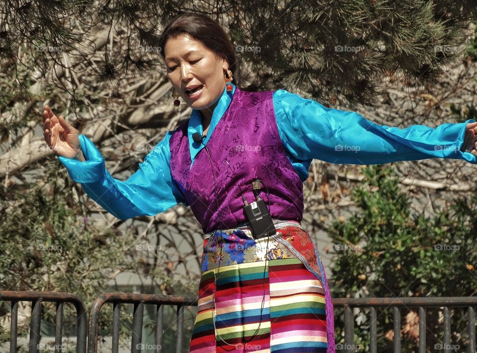 Tibetan Culture. Woman In Traditional Costume Performing A Tibetan Folk Dance
