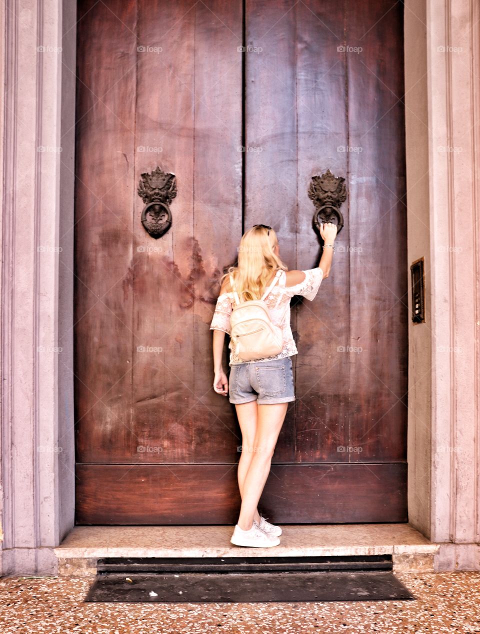 The girl at the big wooden door