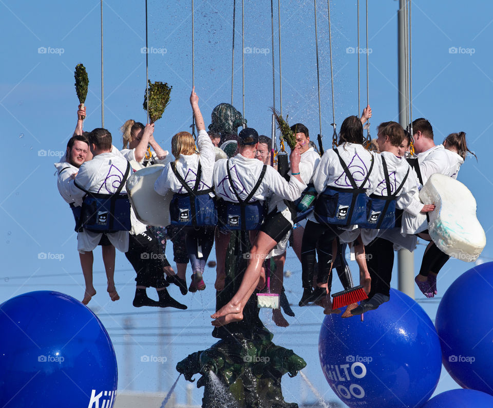 Helsinki, Finland - April 30, 2019: Members of the Aalto University Student Union’s Community section wash and perform traditional spring cleaning to the statue of Havis Amanda in the center of Helsinki as highlight of the Finnish Mayday carnival.