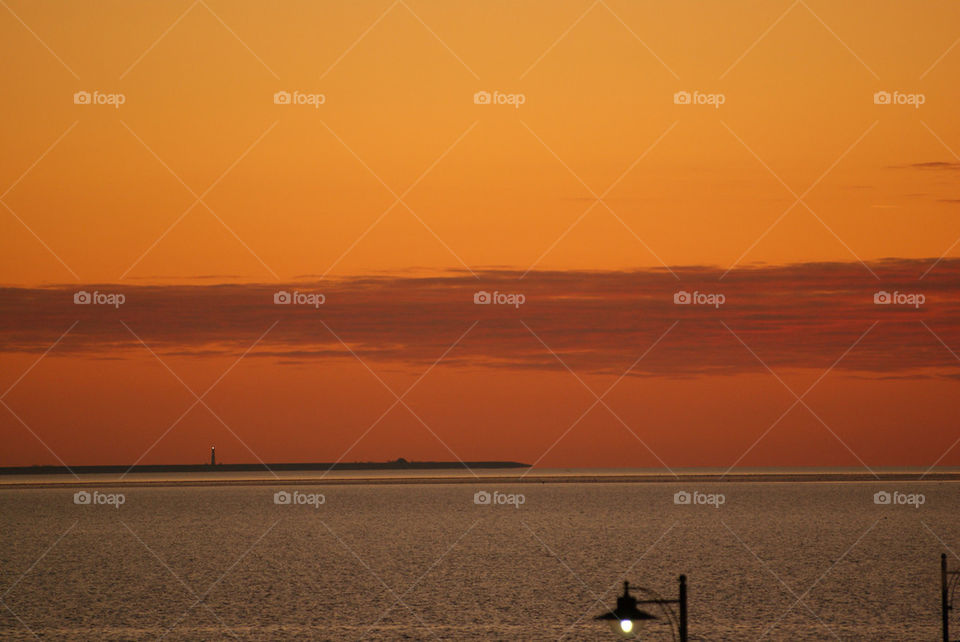 sunset sea lighthouse north by corneliam