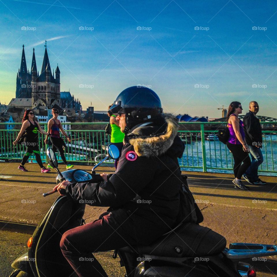 Motorcycle on a bridge. Cologne scene with Kölner Dom in the background