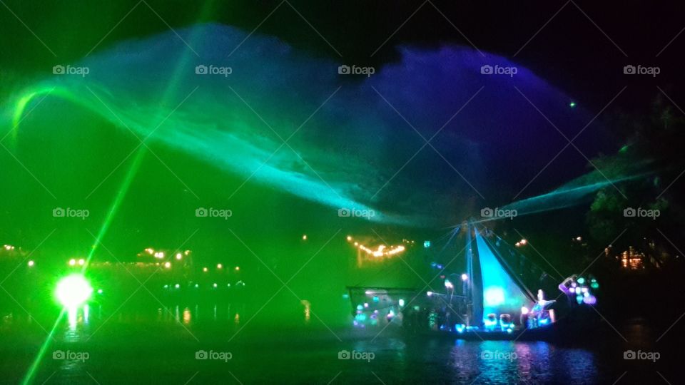 The misty water lights the way for the illuminated ship on Discovery River during Rivers of Light at Animal Kingdom at the Walt Disney World Resort in Orlando, Florida.