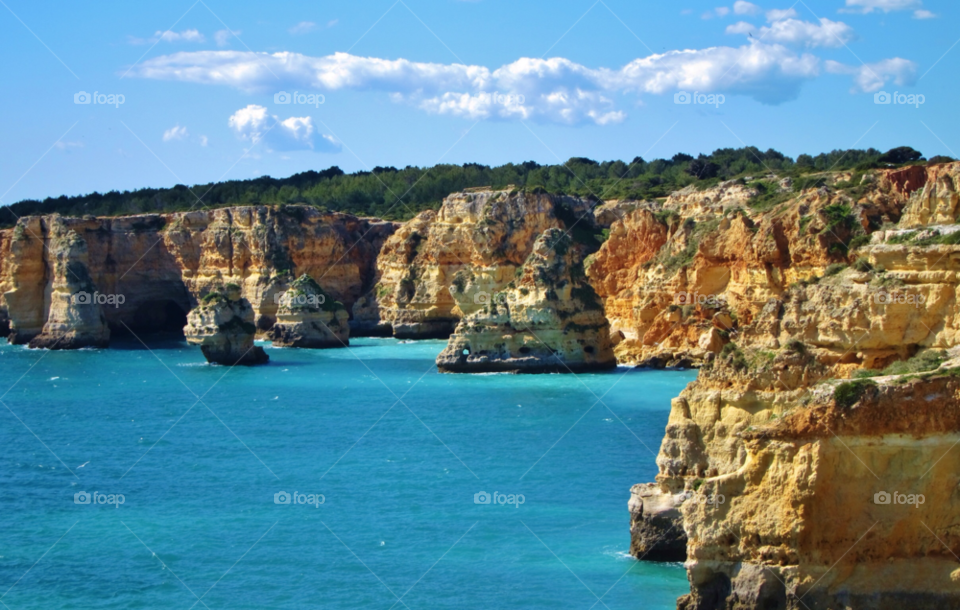 sun cliffs blue water algarve by ponchokid