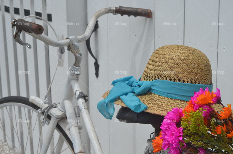 White Vintage Bike Handles With Sunhat And Vibrant Colored Flowers
